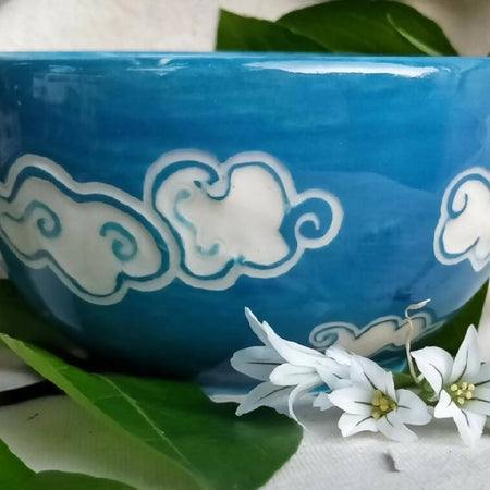 Blue sky, white clouds. Small hand made condement bowl