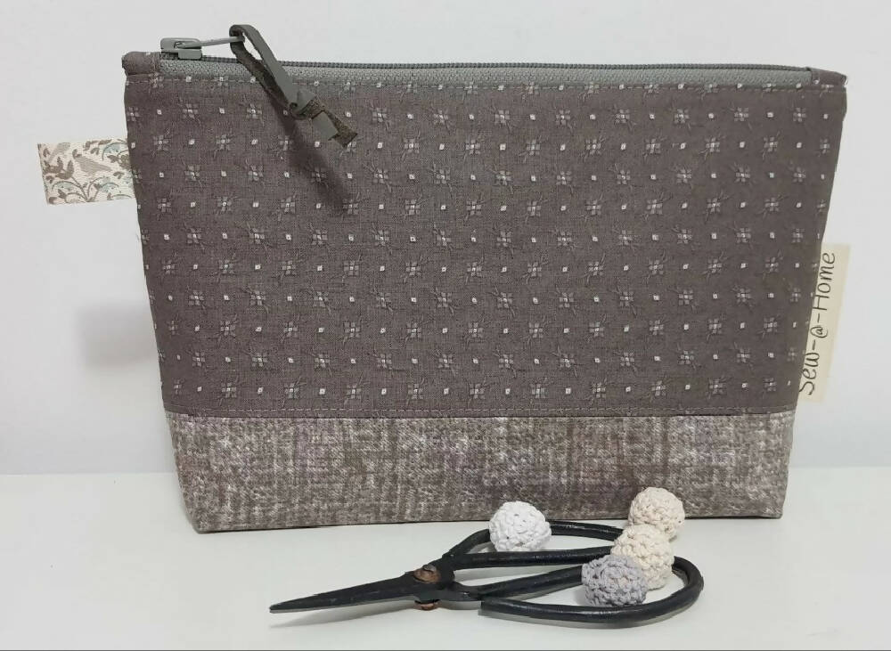 Taupe zippered pouch/bag.