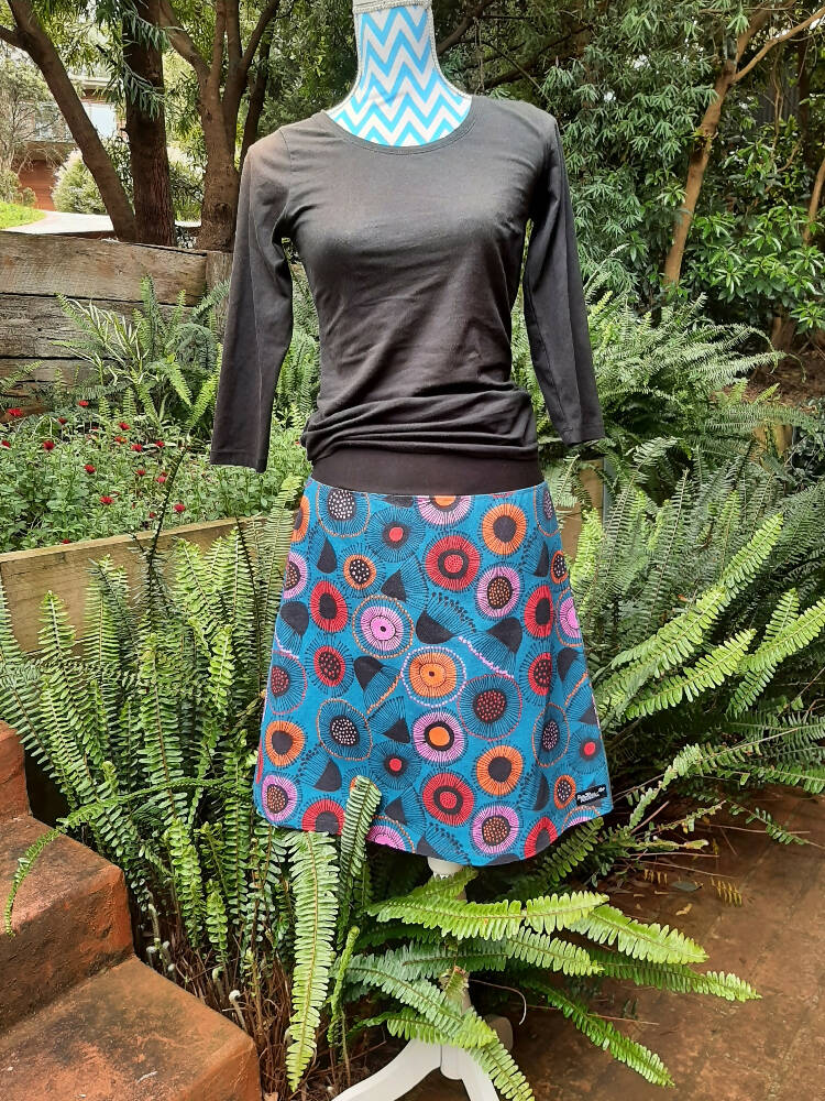 Blue skirt with orange, red and pink gum blossoms