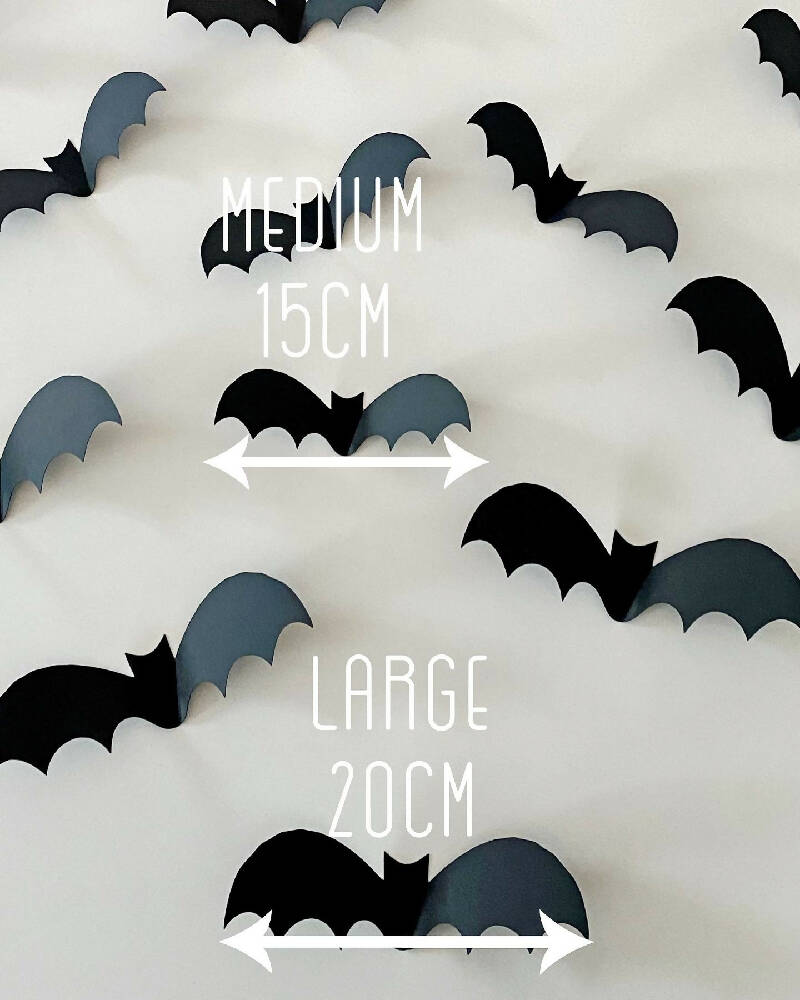 Halloween Bat shapes. Black 3D bats, Spooky holiday decorations.