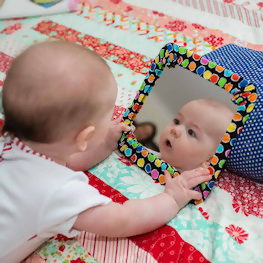 Cotton Casing Mirror play- White fabric with bright Christmas colours with parcels and ribbons. Reds, blacks, green and dots