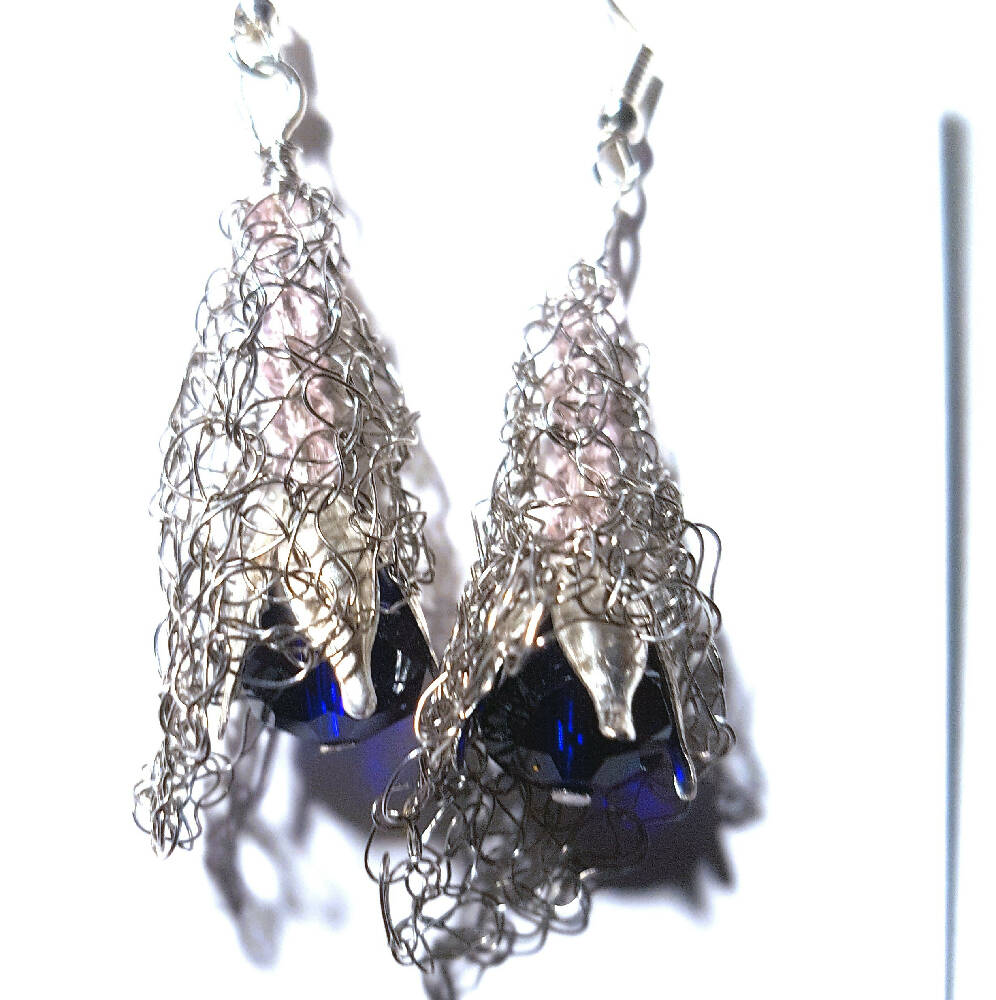 Dangle earring, silver crochet wire with blue crystal.