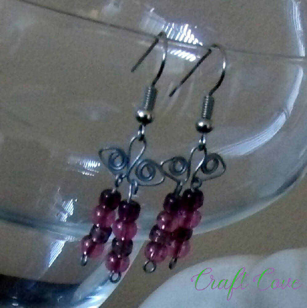 Earrings wire worked in Squiggly shapes with beads