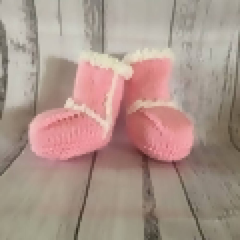 Pink and white knitted beanie and ugg booties.