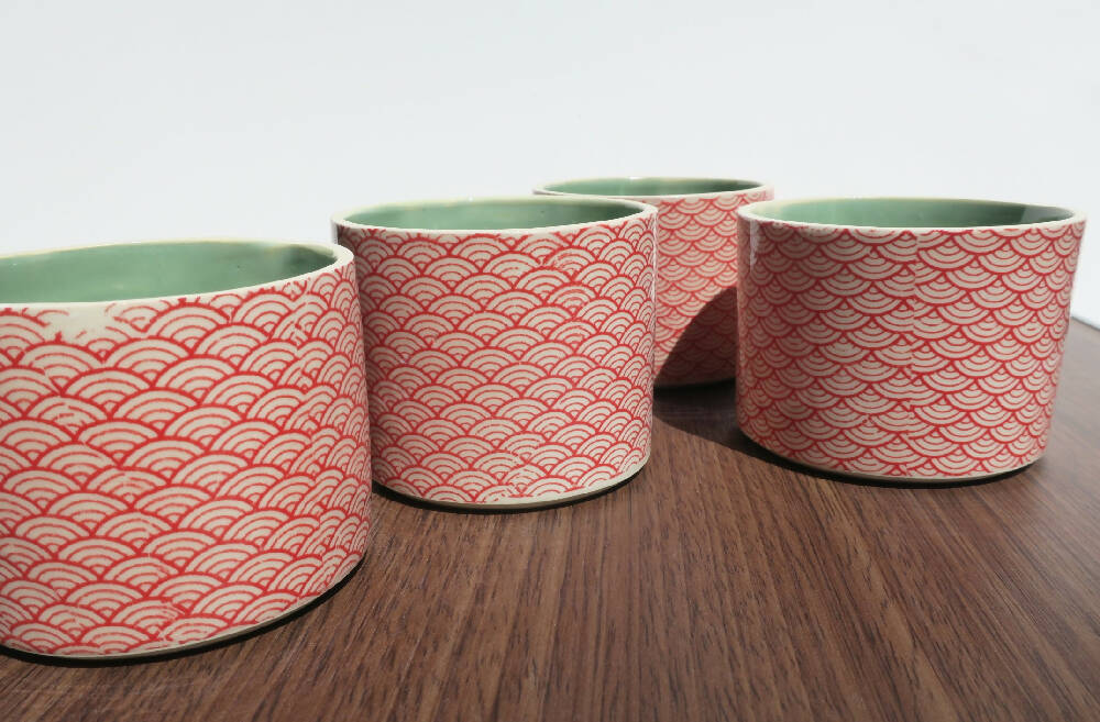 Red stenciled ceramic planters