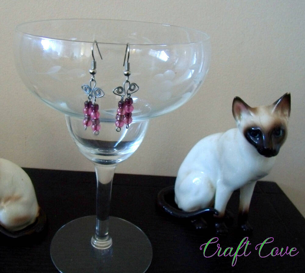 Earrings wire worked in Squiggly shapes with beads